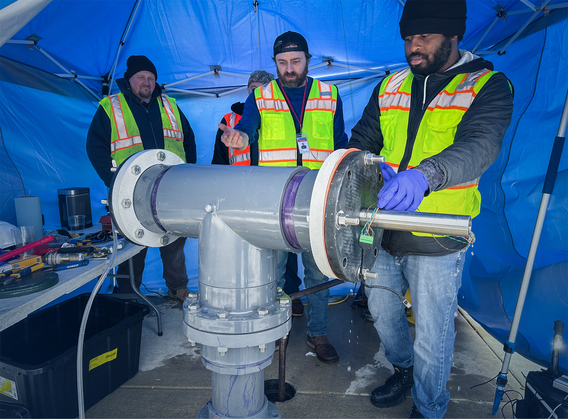 Motmot team members testing hydrant-based deployment of their autonomous underwater robot within a controlled water distribution system at ACM.