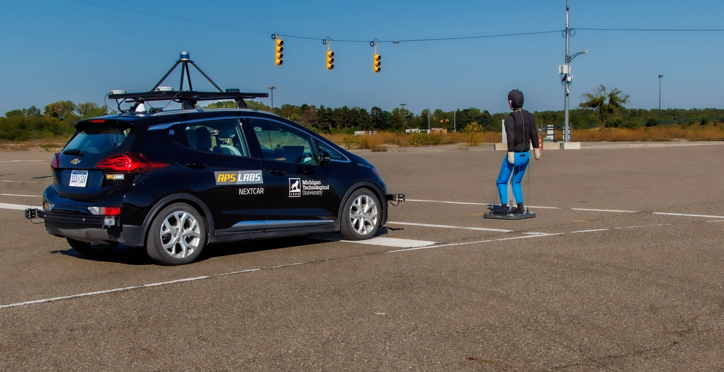 Michigan Tech APS LABS vehicle conducting vulnerable road user testing on the ACM track