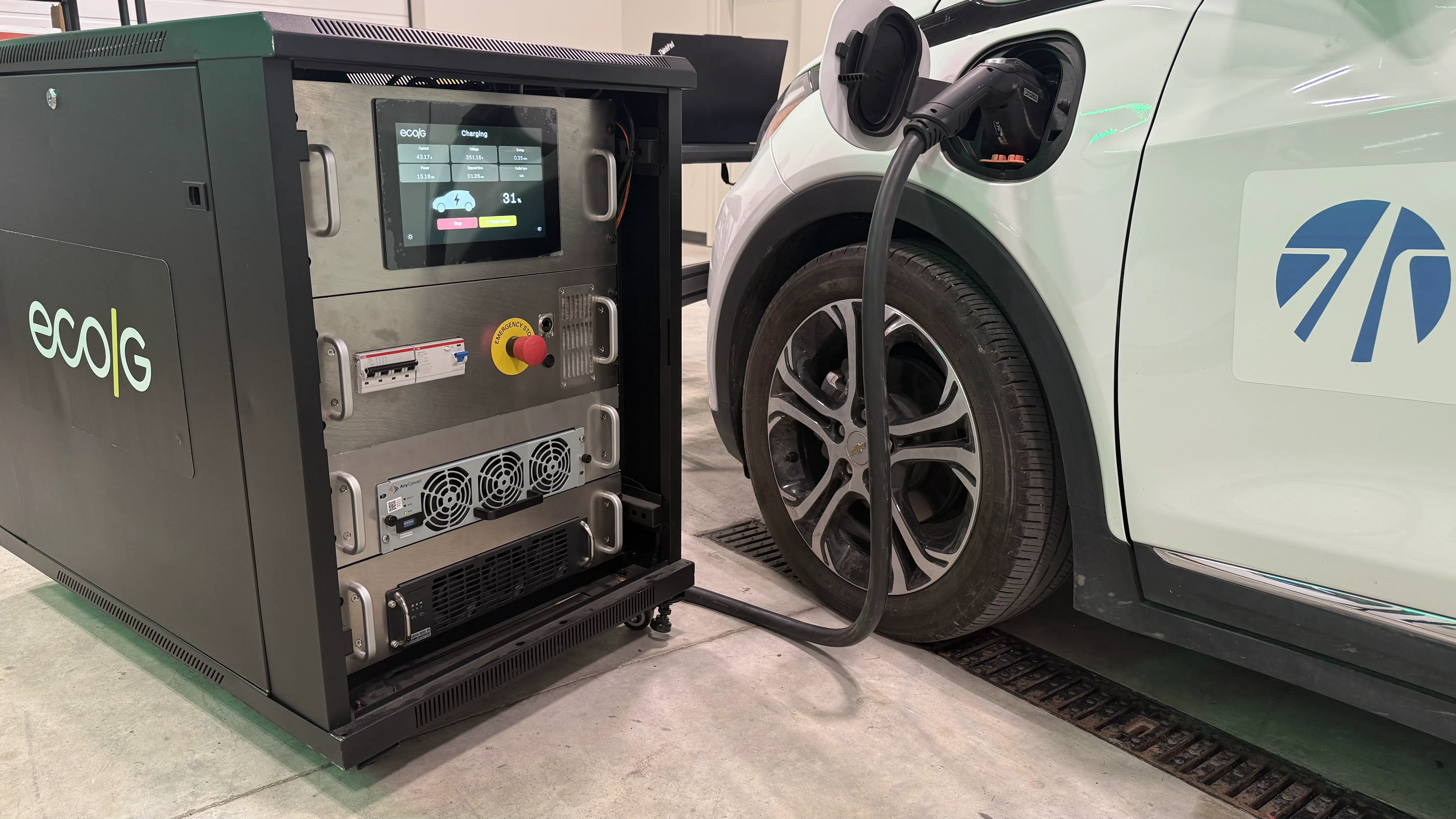 An EcoG-powered charging unit charging an electric vehicle at ACM’s EV Basecamp