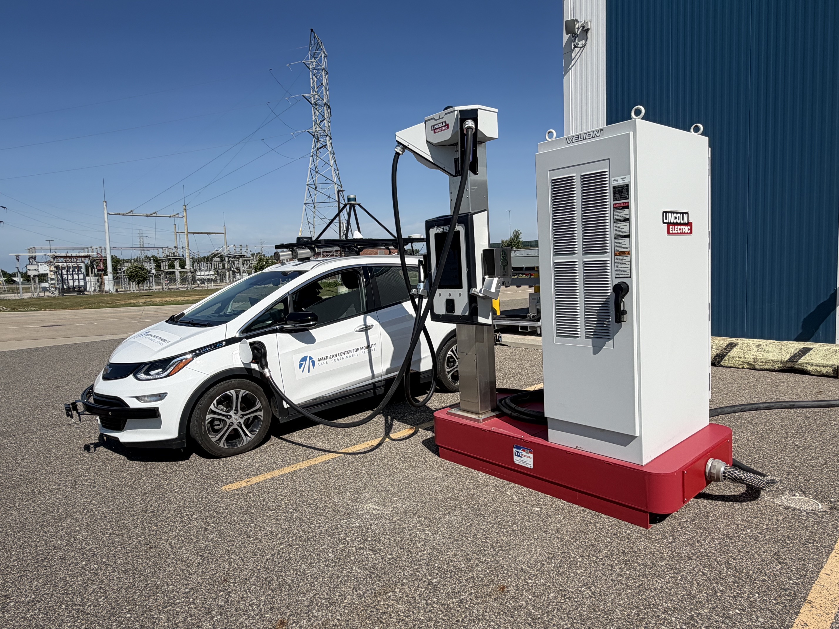 Lincoln Electric’s Velion® DC fast charger charging an ACM test vehicle outdoors at ACM’s EV Charging Basecamp